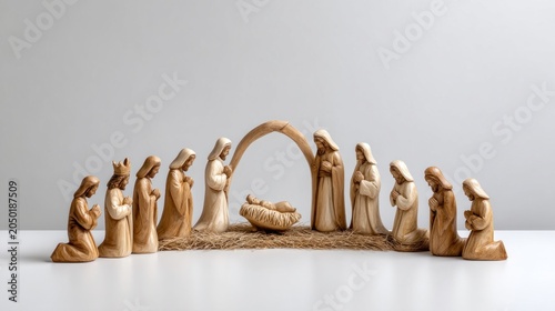 Wide panoramic still life of intricately carved nativity scene featuring figures in natural wood tones, showcasing craftsmanship and holiday spirit with copy space