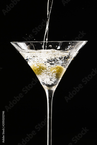 Pouring of tasty martini co...