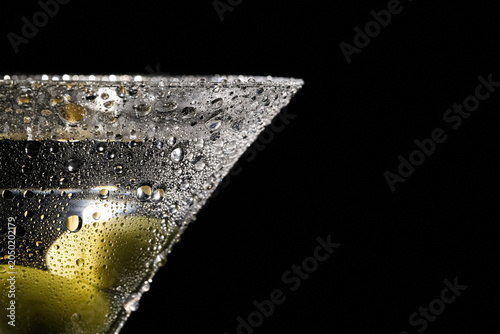 Glass of tasty martini with olives on dark background, closeup