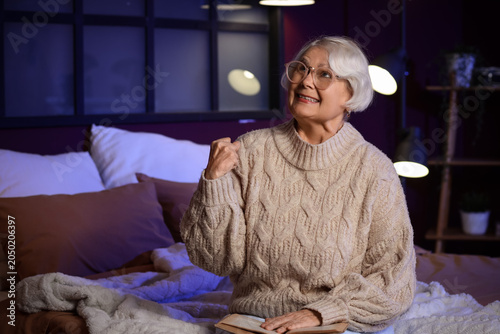 Angry senior woman with boo...
