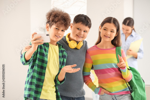 Teenagers taking selfie at ...