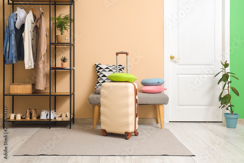 White suitcase with neck pi...
