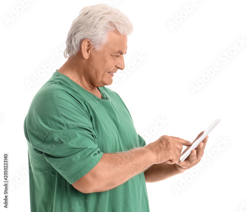 Senior man using tablet com...