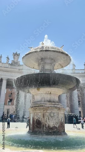 Baroque fountain with cascading water in Saint Peter's Square Vatican Rome