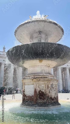 Baroque fountain with cascading water in Saint Peter's Square Vatican Rome