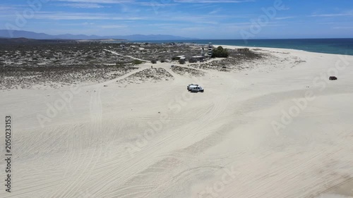 Drone footage of off-road vehicle on Punta Arena beach in Baja California Sur.