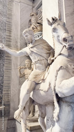 Ancient Greek and Roman marble sculptures displayed in ornate museum gallery