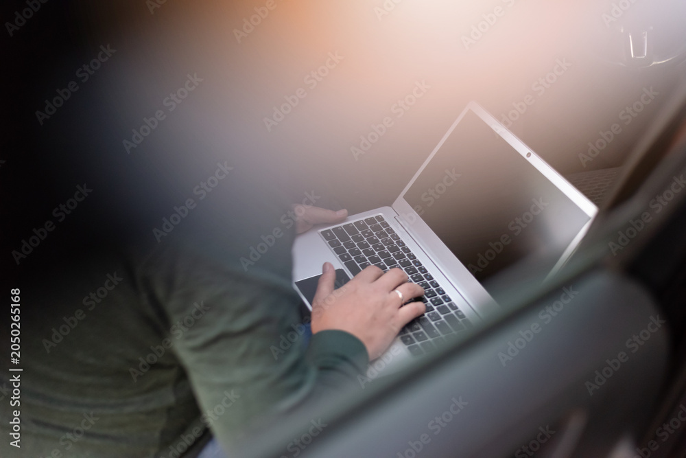 Fototapeta premium Digital Nomad Working on Laptop in Vehicle During Evening Travel Stop