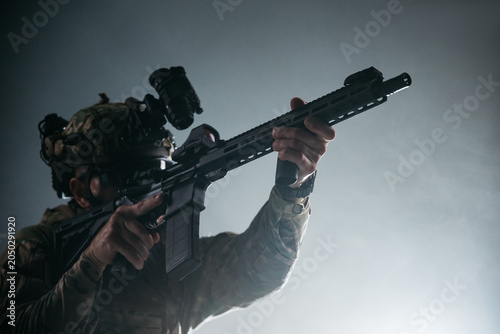 Quadro em tela Modern military operator with tactical rifle and night vision gear in dramatic l