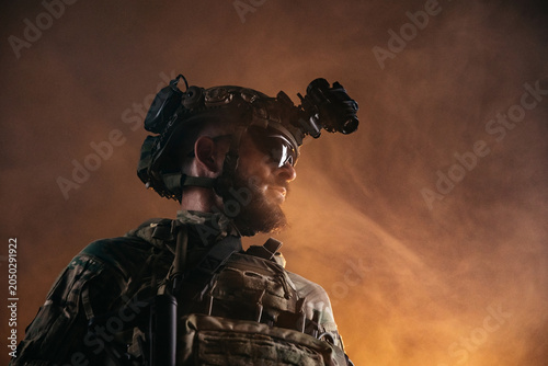 Cuadro en lienzo Close up military operator with advanced night vision gear against warm smoky ba