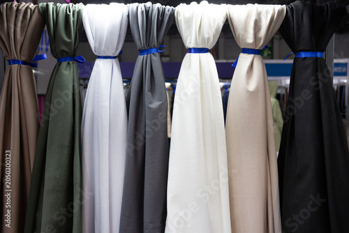 фотографія Multicolored fabric hangs in a fabric store for display to a customer