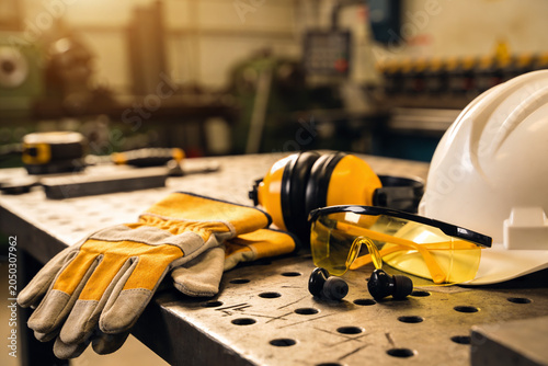Canvas-taulu Essential personal protective equipment laid out on a workshop table for safety