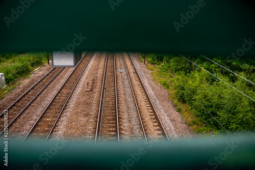 High angle view of parallel railway tracks framed through a narrow gap