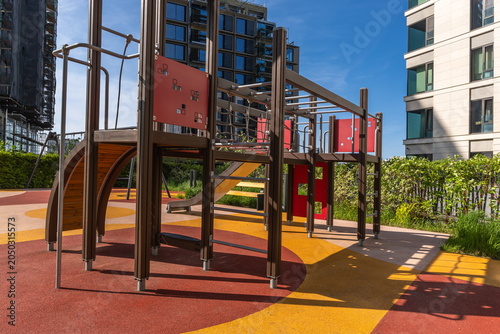 Billede på lærred Children can enjoy playtime at this playground featuring various climbing structures and slides