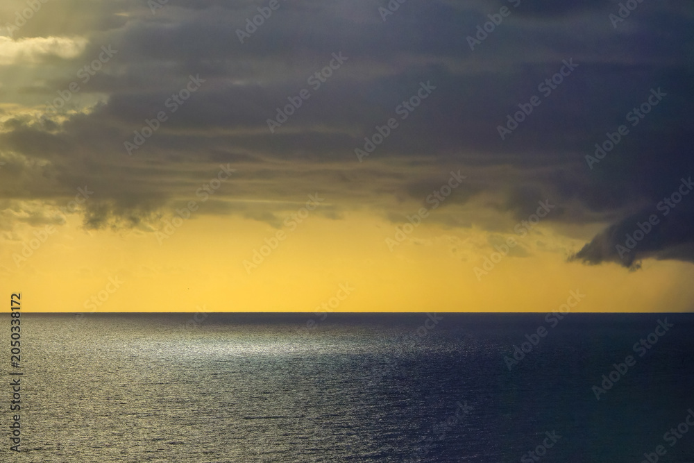 Obraz premium Dramatic storm clouds over the Mediterranean Sea at sunset