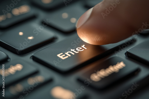 Close up of human finger pressing glowing enter key button on black computer laptop keyboard conceptual image for starting next step submitting data confirmation