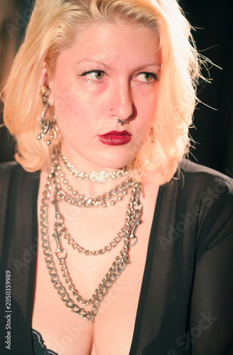 This artistic close-up emphasizes the jewelry and detailed makeup of a woman, capturing the essence of beauty and self-expression in a visually striking composition.