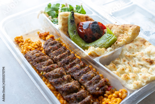 traditional Turkish Adana kebab served with grilled tomatoes and green peppers 