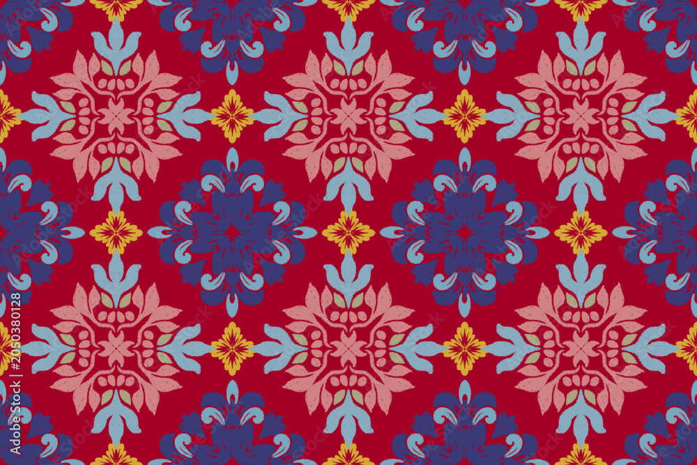 Fototapeta premium ikat seamless vector pattern featuring symmetrical floral motifs in vibrant red, blue, pink, and gold tones. Decorative ethnic ornament design with repeating geometric elements