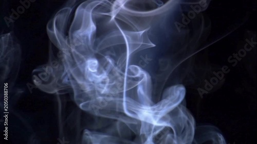 Rotation of the smoke veils under the lights on a black background Realistic dry ice smoke clouds fog overlay smoke slowly floating through space against black background White smoke on black 4k