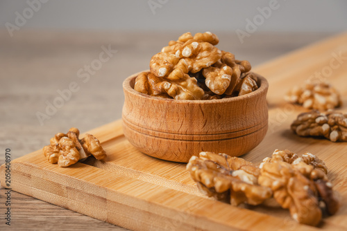 Canvas Print Wooden bowl holds fresh walnuts