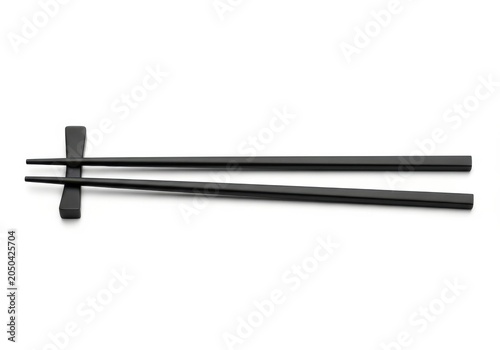 Elegant Pair of Black Chopsticks on a Matching Holder Isolated on a Clean White Background for Asian Dining