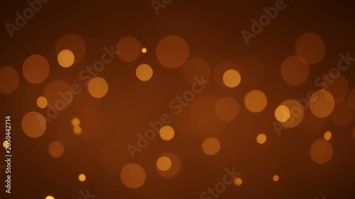 Abstract bokeh light glowing warm orange background with soft blurred circles and festive shimmer pattern