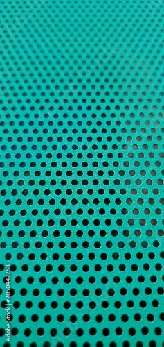 Photos Abstract turquoise perforated metal texture with repeating circular holes, geometric industrial pattern and modern technology background