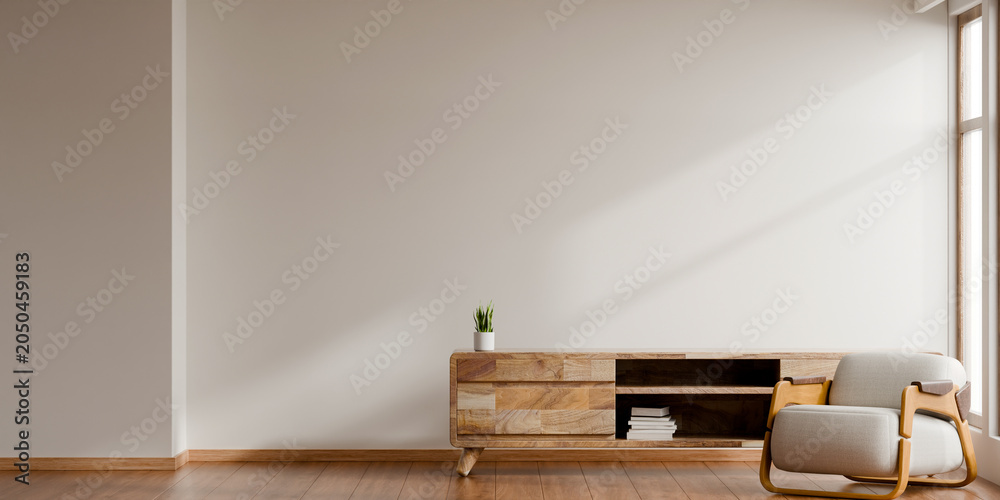 Obraz premium Minimalist living room interior design with comfortable armchair, wooden cabinet, and blank empty wall for home decoration mockup- 3D rendering