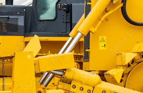Принти на полотні Close up hydraulic system of yellow bulldozer at industrial construction site, heavy machinery engineering detail with mechanical cylinder and steel component for infrastructure and excavation work