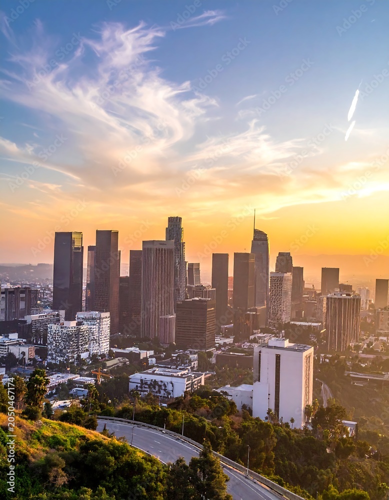 Obraz premium A cityscape at sunset with a curved road and skyscrapers