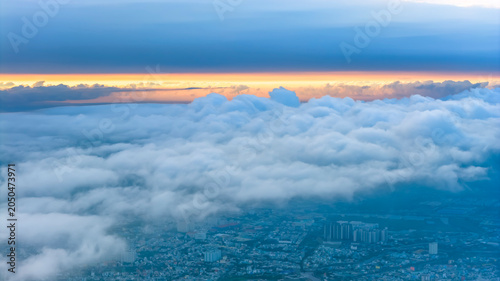 Aerial view of Saigon cityscape at morning with misty sky in Southern Vietnam. Urban development texture, transport infrastructure and green parks