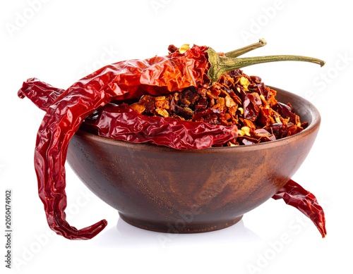 A wooden bowl filled with dried chili peppers and flakes