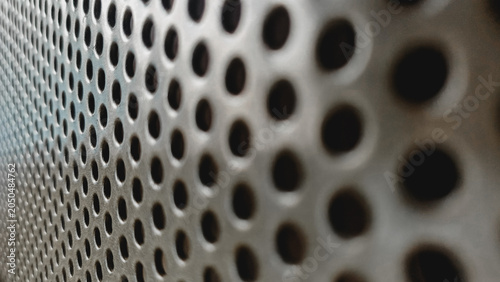 фотографія Close up of a grey perforated metal sheet texture