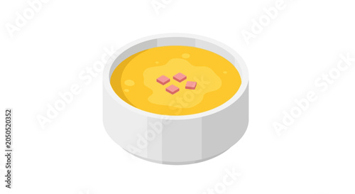 Creamy yellow soup garnished with herbs in white bowl.