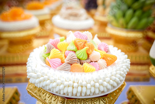 Colorful dessert meringue confection candy sweet pastry assortment closeup on ornate gold tray, traditional celebration treat with pastel topping, soft bokeh background