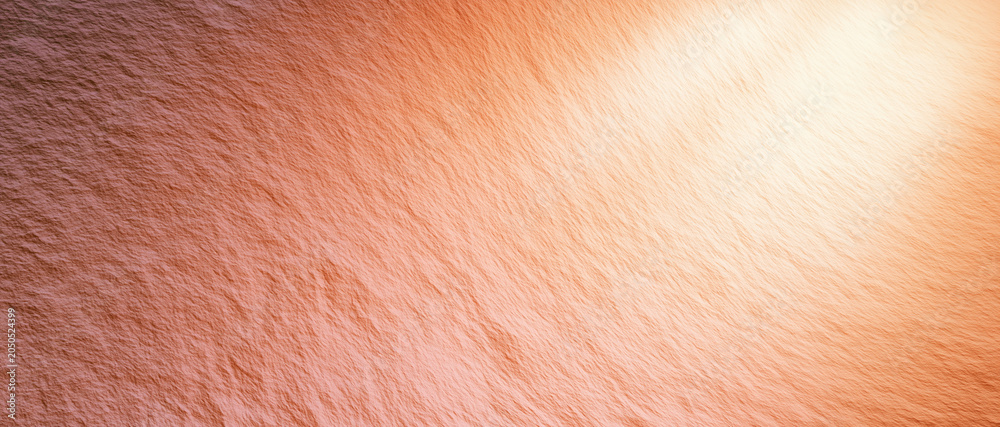Naklejka premium Orange textured surface with light