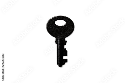 Single black modern key with serrated edge on white background lock security access