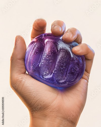 Hand holds colorful squishy toy that exhibits squish and glitch effect, providing satisfying tactile experience
