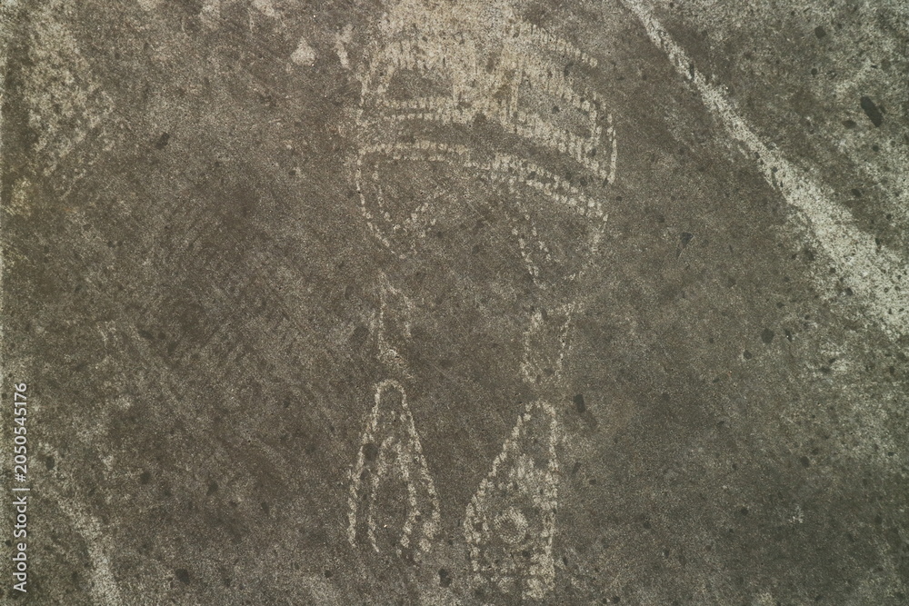Fototapeta premium Abstract Ancient Rock Carving of a Symbolic Figure Found on Weathered Stone Surface Showcasing Prehistoric Artistic Expression and Archaeological Heritage
