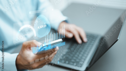User reviewing expenses and financial insights on a smartphone and laptop, visualizing budgeting, spending analysis, savings tracking, and personal finance management through a digital dashboard.