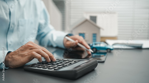 Foto Financial planning for mortgage and loan calculations using a calculator with home and vehicle models