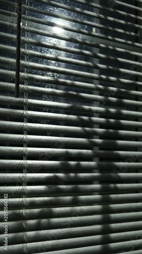 Shadow on a closed blind window.