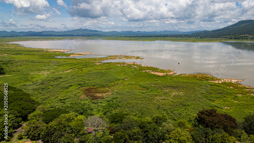 Canvas Print A wide aerial shot of Lam Takhong reservoir surrounded by hills and greenery in Nakhon Ratchasima