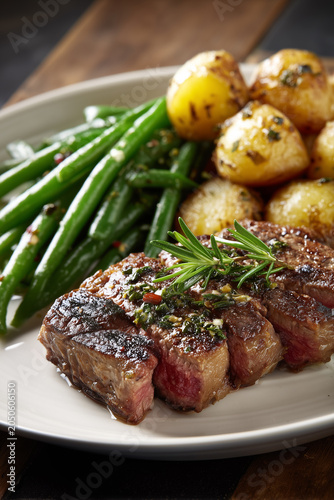 Delicious grilled steak served with green beans and roasted potatoes