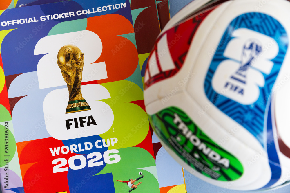 Naklejka premium LONDON, UK - JUNE 2026: Official FIFA World Cup 2026 match ball displayed with tournament branding and sticker collection album