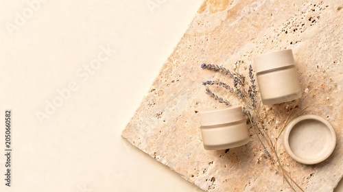 Natural cosmetic jars with lavender on travertine stone surface