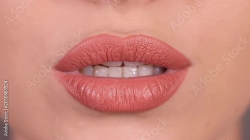 Closeup lip movement with natural glossy lipstick in gentle expression sequence