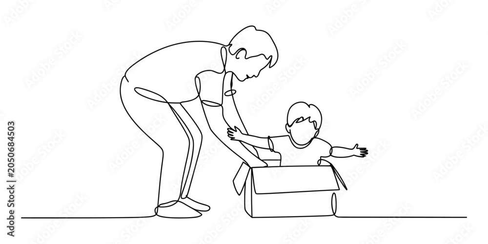 Fototapeta premium Father playing with baby sitting in a cardboard box