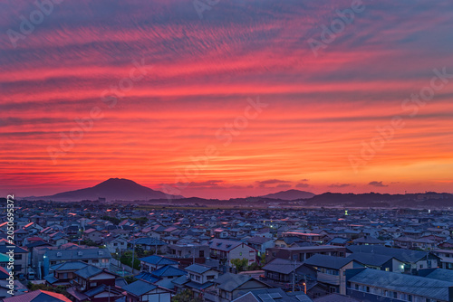 Dramatic sunset over city skyline and distant mountains, In Fukuoka, Japan